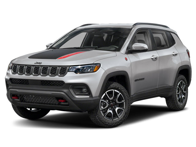 A silver 2026 Jeep Compass with a black hood and red accents, parked on rugged terrain.